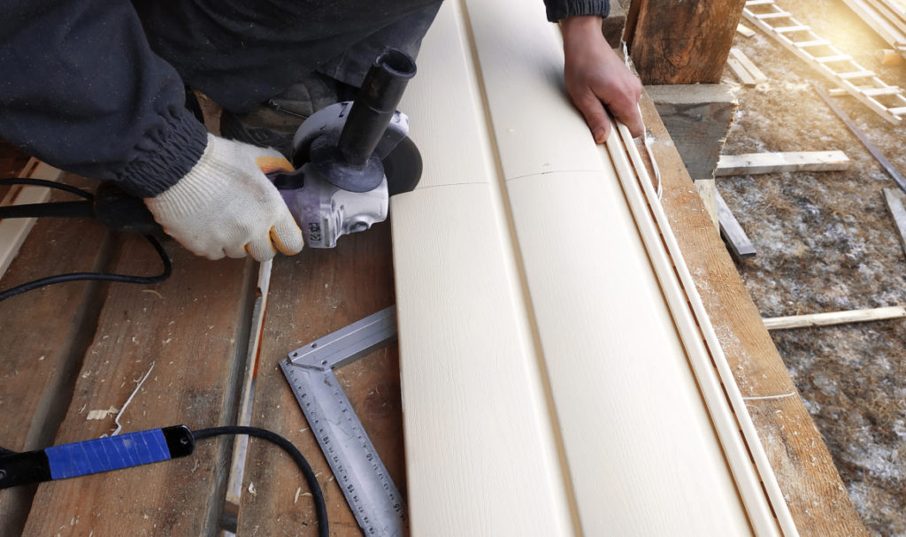 PDX Roofing and Siding professional installing residential siding on a Portland home