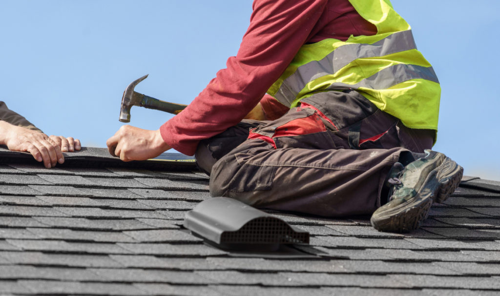 PDX Roofing and Siding professional inspecting shingles on a residential roof in Portland before rainy season
