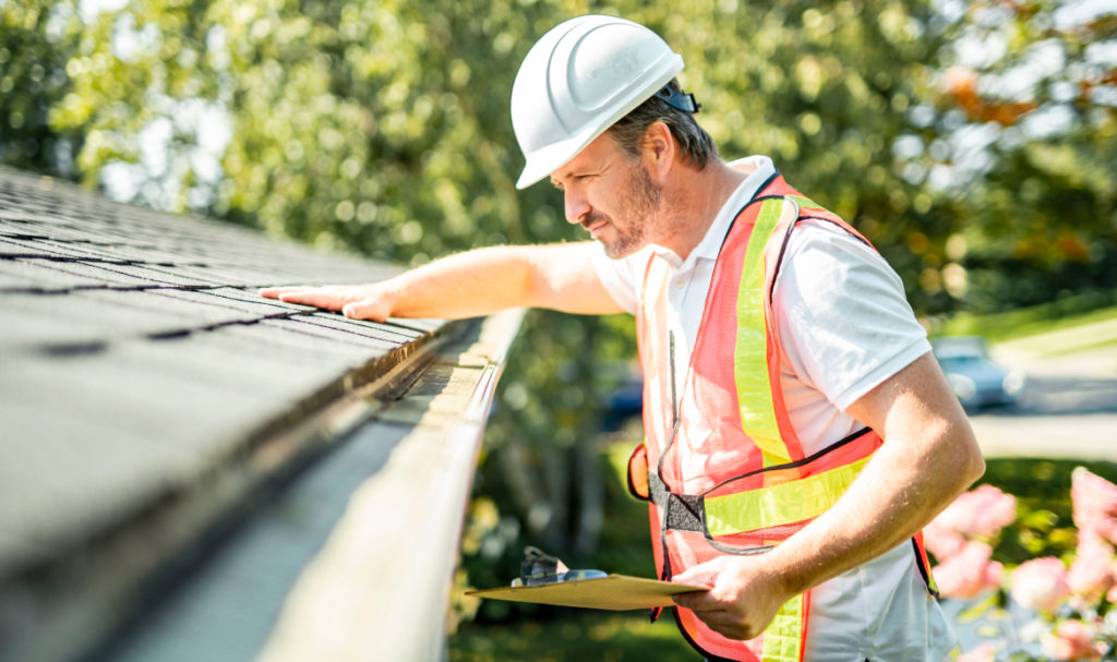 Roofing professional inspecting a Portland home roof to prepare for fall rain and wind