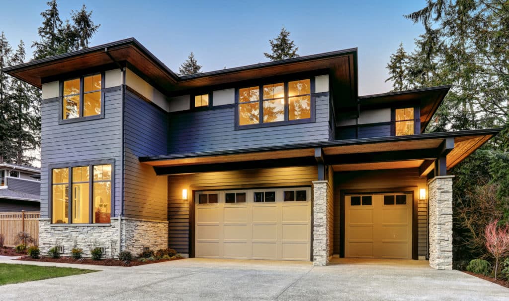 Modern Portland home showcasing exterior design trends with dark color palette, natural wood accents, and sustainable materials